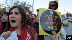 A woman holds a placard as thousands of members of Turkey's main opposition Republican People's Party march to the parliament in Ankara, Turkey, Nov. 22, 2016. 