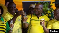 South African President Cyril Ramaphosa, left, and former president Jacob Zuma, center, celebrate the 107th anniversary of the African National Congress, in Durban, South Africa, Jan. 8, 2019.