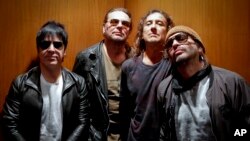 FILE - Members of the Mexican rock band Maná, drummer Alex González, from left, vocalist Fher Olvera, bassist Juan Calleros and guitarist Sergio Vallín pose during an interview in New York, Oct. 25, 2016.