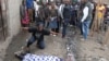 FILE - A woman cries over the body of man who was killed by police, witnesses said, in Mathare slum in Nairobi, Kenya, Aug. 9, 2017.