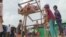 Children enjoy a manual Ferris wheel ride during the Eid Al-Adha religious celebration at the Kutipalong refugee camp in Cox's Bazar this week.
