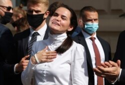 FILE - Belarusian opposition leader Sviatlana Tsikhanouskaya interacts with supporters in Warsaw, Poland, Sept. 9, 2020.
