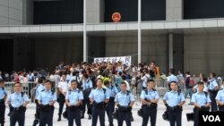 警方准备在公民广场清场前坚守的学生和市民高呼口号（美国之音图片/海彦拍摄）