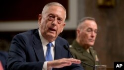 Defense Secretary Jim Mattis, left, accompanied by Joint Chiefs Chairman Gen. Joseph Dunford, speaks before the Senate Armed Services Committee on Capitol Hill in Washington, Oct. 3, 2017. 