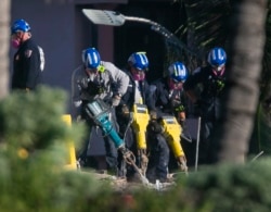 Rescue teams use jack hammers to chip through debris and rubble as they continue to look for survivors at the partially collapsed Champlain Towers South Condo building in Surfside, Fla., July 3, 2021.