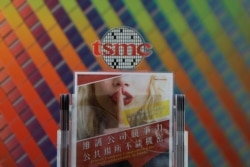 FILE - A leaflet that asks employees to protect the company's confidentiality is seen at a reception in Taiwan Semiconductor Manufacturing Co (TSMC), in Hsinchu, Taiwan, Aug. 31, 2018.