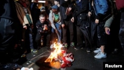 Following President-elect Donald Trump's election victory, protesters burn a U.S. flag outside Trump Tower in New York, Nov. 9, 2016.