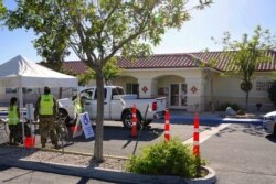 FILE - Members of the Nevada National Guard offer coronavirus vaccines at a mobile vaccination clinic held at a tribal health center on the Fallon Paiute-Shoshone Reservation and Colony on May 18, 2021 in Fallon, Nev.
