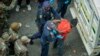 South African police officers, backed by soldiers, arrest illegal immigrants and foreign nationals during a raid in Johannesburg in the early morning hours of May 8, 2015.