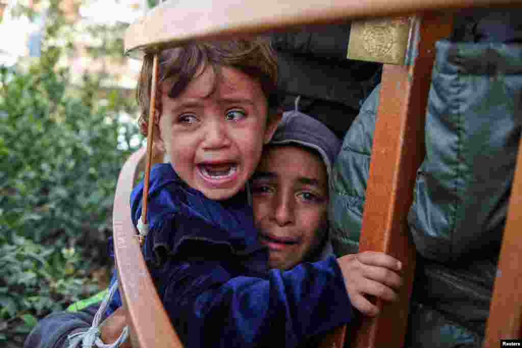 Children cry during the funeral of Palestinian Anas Al-Masri, who succumbed to wounds sustained from an Israeli strike, in Khan Younis in the southern Gaza Strip.