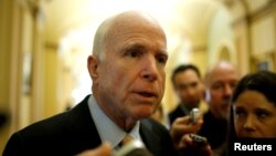 Senator John McCain, an Arizona Republican, speaks to reporters as he arrives for the Republican policy luncheon on Capitol Hill in Washington, Feb. 14, 2017. 