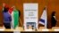 FILE - Israeli parliament employees set up a Palestinian and Israeli flag ahead of a meeting between Israeli parliament members and a delegation of Palestinian politicians and businessmen aimed at encouraging Israeli-Palestinian negotiations, at the Knesset, the Israeli parliament, in Jerusalem, July 31, 2013.