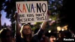 Activists gather outside the U.S. Supreme Court to hold a vigil in opposition to U.S. Supreme Court nominee Brett Kavanaugh in Washington, Oct. 3, 2016.