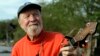 FILE - Folk singer Pete Seeger plays his banjo in Beacon, New York, May 5, 2006.