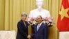 Australian Foreign Minister Penny Wong, left, and Vietnamese President Nguyen Xuan Phuc shake hands in Hanoi, Vietnam Monday June 27, 2022. (AP Photo/ Hoang Duong)