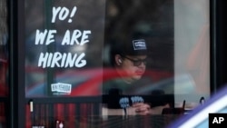 FILE - A hiring sign is displayed at a restaurant in Schaumburg, Ill., Friday, April 1, 2022. 
