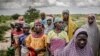A group of women wait for the arrival of a United Nations convoy near the village of Sabon Machi, Maradi region, Niger on Aug. 16, 2018. 