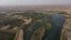 This picture taken on June 12, 2022 shows an aerial view of the Tigris river which is witnessing lower levels of water due to climate change and repeated heatwaves. at Hammam al-Alil, south of Iraq's northern city of Mosul. 