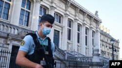 FILE - A French Gendarme patrols outside Paris' courthouse ahead of the start of the trial of the Nov. 13, 2015 Paris attacks' defendants. proceedings. 