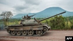 FILE - A Congolese army tank heads towards the front line near Kibumba in the area surrounding the North Kivu city of Goma during clashes between the Congolese army and M23 rebels, May 25, 2022.