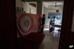 A boy receives a vaccine for COVID-19 at a private vaccination center in Gauhati, India on April 10, 2022. (AP Photo/Anupam Nath, File)