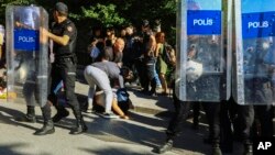 A protester is detained during the LGBTQ Pride March in Ankara, Turkey, July 5, 2022. Police in Turkey’s capital broke up an LGBTQ Pride march and detained dozens of people.