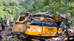 This photograph provided by Deputy Commissioner's office, Kullu, shows the wreckage of a passenger that bus slid off a mountain road and fell into a deep gorge near Kullu, Himachal Pradesh state, July 4, 2022. (Deputy Commissioner's office, Kullu via AP