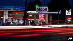Motorists stop for fuel at gas stations in Detroit, July 5, 2022. The average U.S. price of regular-grade gasoline plunged 19 cents over the past two weeks to $4.86 per gallon. 
