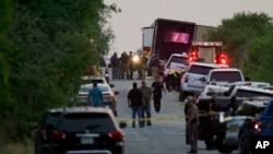 Police and other first responders work the scene where officials say dozens of people have been found dead and others were taken to hospitals with heat-related illnesses after a semitrailer containing suspected migrants was found on June 27, 2022.