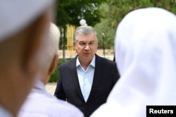 FILE - Uzbek President Shavkat Mirziyoyev meets with local residents in Nukus, capital of the northwestern Karakalpakstan region, Uzbekistan, July 3, 2022. (Press Service of President of Uzbekistan/Handout via Reuters)