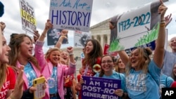 FILE - Anti-abortion protesters celebrate following the Supreme Court's decision to overturn Roe v. Wade, federally protected right to abortion, outside the Supreme Court in Washington.