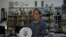 Joseph Tso, owner of Yuet Tung China Works, Hong Kong's last hand-painted porcelain factory, holds a plate with UK royal print in Hong Kong, June 8, 2022. Tso is the third-generation owner of the factory.