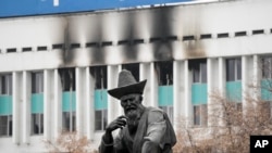 FILE - A sculpture of a Kazakhstani man is seen in front of the city hall building in the central square blocked by Kazakhstan troops and police in Almaty, Kazakhstan, Jan. 11, 2022. Authorities in Kazakhstan said nearly 8,000 people were detained by police during protests that descended into violence.