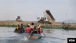 រូប​ឯកសារ៖ ប្រជាពលរដ្ឋ ជិះទូក​ទៅកាន់​កន្លែង​គ្រឿង​ចក្រ​កំពុង​ចាក់​ថ្ម​ចូល​បឹង​តាមោក ដែល​ចំ​កន្លែង​ពួកគេ​ចិញ្ចឹម​ត្រី ក្នុង​សង្កាត់​សំរោង​ត្បូង​ ​ខណ្ឌ​ព្រែក​ព្នៅ​ ​រាជ​ធានី​ភ្នំពេញ ថ្ងៃទី២៧ ខែមិថុនា ឆ្នាំ២០២២។ (ហាន ណូយ/វីអូអេ)