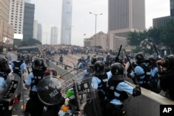 FILE - Riot police gather face off with demonstrators near the Legislative Council in Hong Kong on June 12, 2019. (AP Photo/Kin Cheung, File)