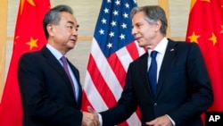 US Secretary of State Antony Blinken, right, shakes hands with China's Foreign Minister Wang Yi during a meeting in Nusa Dua on the Indonesian resort island of Bali, July 9, 2022.