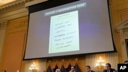 A note is displayed as the House select committee investigating the Jan. 6 attack on the U.S. Capitol holds a hearing at the Capitol on June 28, 2022. 