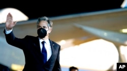 US Secretary of State Antony Blinken waves after disembarking his airplane at Bangkok Don Mueang International Airport in Bangkok, Thailand, July 9, 2022.