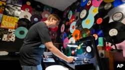 Tyler Bryant listens to finished record albums for flaws in a quality control room at the United Record Pressing facility Thursday, June 23, 2022, in Nashville, Tenn. (AP Photo/Mark Humphrey)