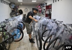 Volodymyr Pozolotin arranges bikes at a bike shop in Kramatorsk, amid Russia's invasion of Ukraine, July 2, 2022.
