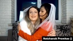 Netchanok "Love" Promkao and Dmytro "Jane" Denysov hug each other in a YouTube video clip, where they talk about their marriage situation