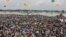 A crowd watches the opening of Bangladesh's longest bridge, which took eight years to build on the Padma River on the outskirts of Dhaka, Bangladesh, June 25, 2022.