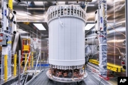 This photo provided by Sanford Underground Research Facility shows the LZ central detector in the clean room at Sanford Underground Research Facility after assembly, before beginning its journey underground in Lead, S.D. (Matthew Kapust/Sanford Underground Research Facility via AP)