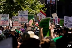 People gather outside a federal courthouse to protest the Supreme Court's ruling on abortion, in Los Angeles, June 24, 2022.