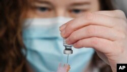 Colleen Teevan prepares the Pfizer-BioNTech vaccine for COVID-19 vaccine on Dec. 14, 2020, in Hartford, Conn. Pfizer and BioNTech said June 29, 2022, that they signed a $3.2 billion deal with the U.S. government for more than 100 million doses of their COVID-19 vaccine.