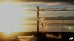 In this photo released by Rocket Lab, Rocket Lab's Electron rocket sits on the launch pad on the Mahia peninsula in New Zealand on May 17, 2022. (Rocket Lab via AP)