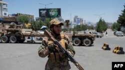 Qabila va diniy liderlar kengashi yig'ilishida ko'chani qo'riqlayotgan Tolibon xizmatchisi. Kobul, 29-iyun, 2022.