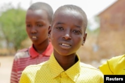 Bashir Nur Salat poses for a photograph with his classmates at the Kabasa Primary School in Dollow, Gedo Region, Somalia May 25, 2022. (REUTERS/Feisal Omar)