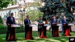 From left, Romanian President Klaus Iohannis, Prime Minister of Italy Mario Draghi, Ukraine President Volodymyr Zelenskyy, France's President Emmanuel Macron and German Chancellor Olaf Scholz attend a press conference in Kyiv, Thursday, June 16, 2022.