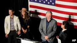 Joe O'Dea, Republican nominee to run for the U.S. Senate seat held by Democrat Michael Bennet, is joined by his wife, Celeste, and other family members on the stage before speaking at a primary election night watch party, June 28, 2022, in Denver. 